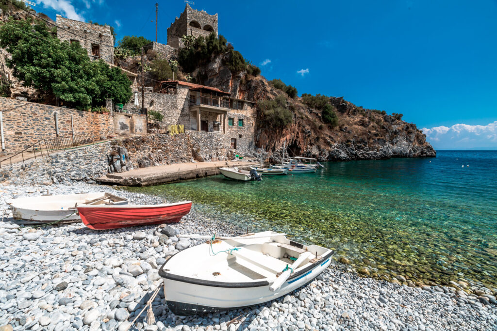Boats on the shore in Alypa Beach, Mania Peninsula, Lakonia, Peloponnese, Greece, a beautiful stone beach in Mani peninsula, Greece