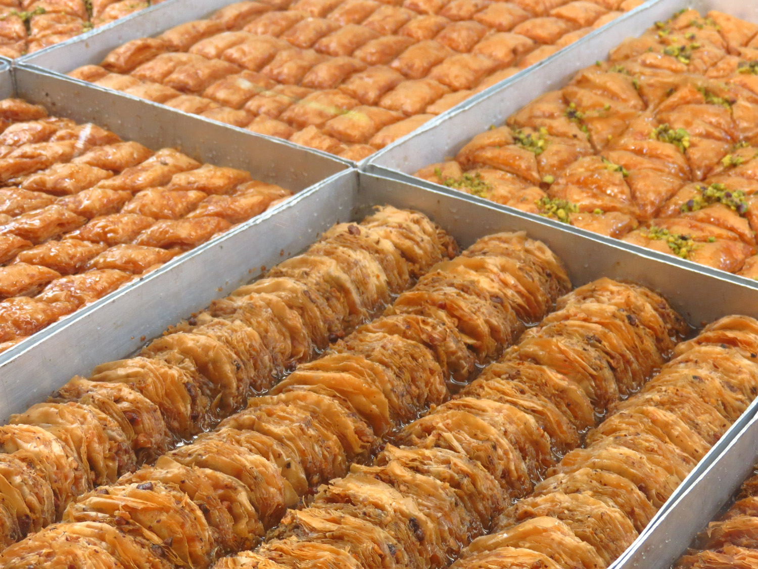 Varieties of handmade baklava on the glass display of a confectionery store in Komotini, North Greece