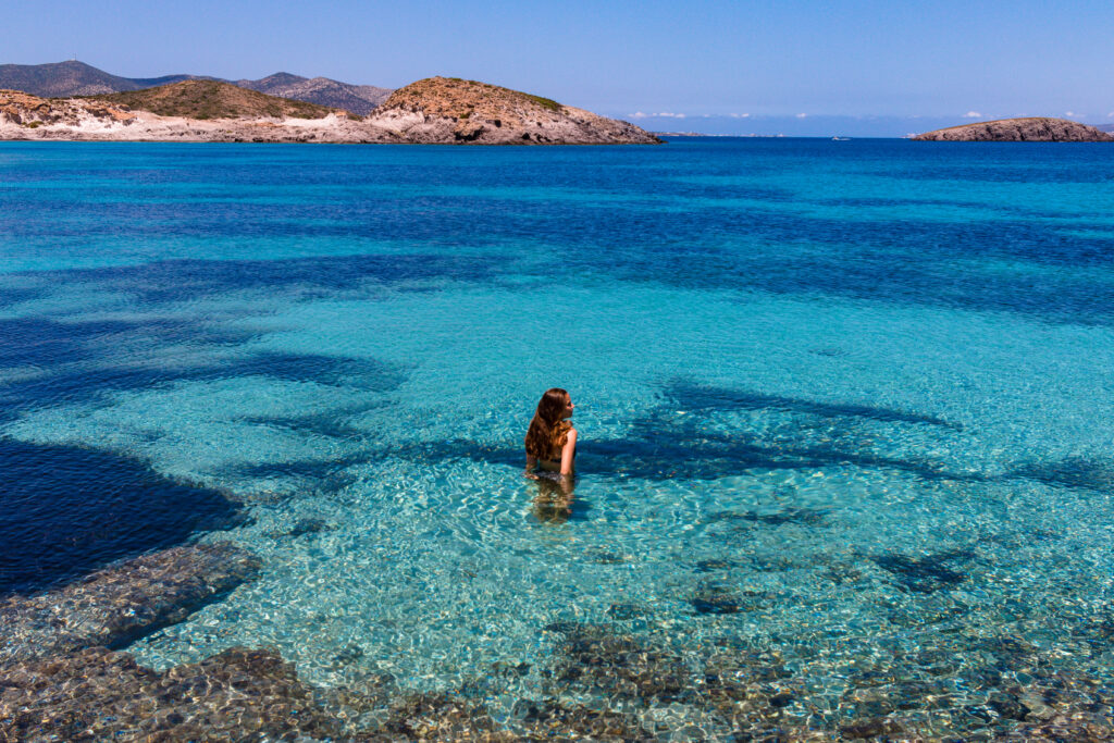 Travel to Antiparos, Cyclades, Greece - Woman in the crystal clear water at Antiparos