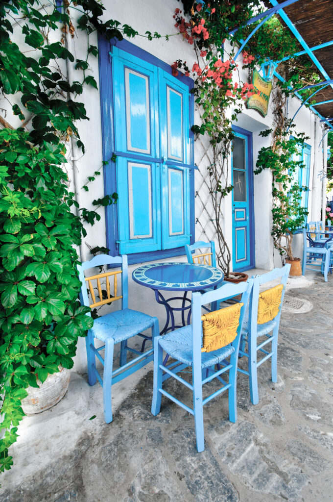 Traditional Greek cafe in an alley in Chora Iraklia, Smaller Cyclades Greece