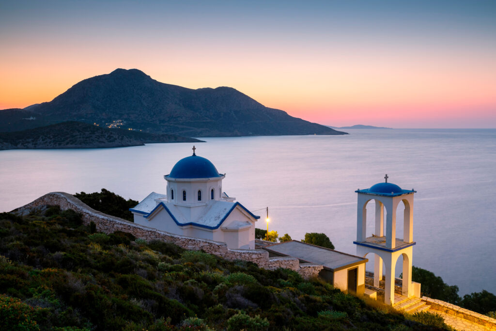 church-on-fourni-island-just-out-of-the-main-town-and-view-of-thymaina-island-at-dusk-greece