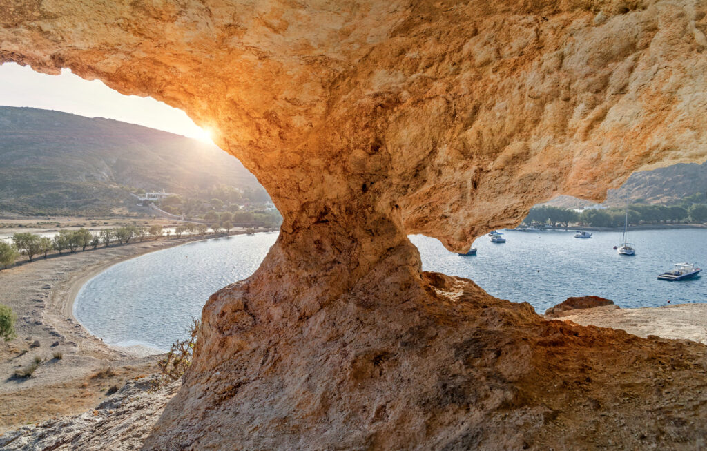 Rock cave sunset at Petra beach in Patmos, Dodecanese Greece