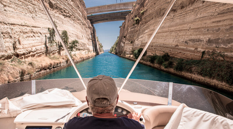 Passing through the Corinth Canal by yacht, Greece. The Corinth Canal connects the Gulf of Corinth with the Saronic Gulf in the Aegean Sea