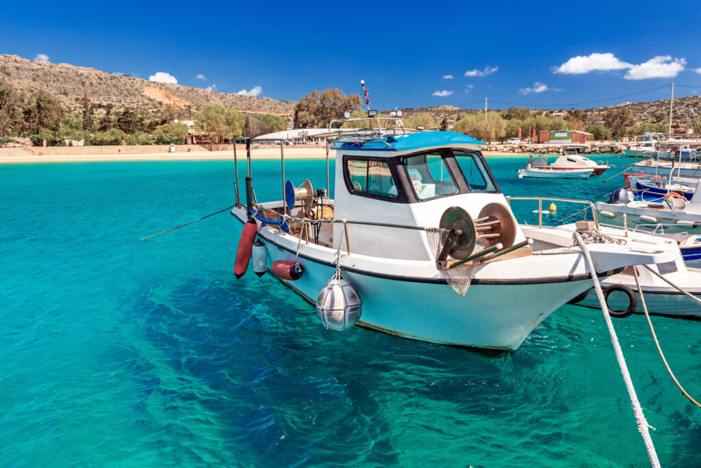 Blue lagoon of Marathi bay with fishing boats in Akrotiri, Chania region in Crete, Greece