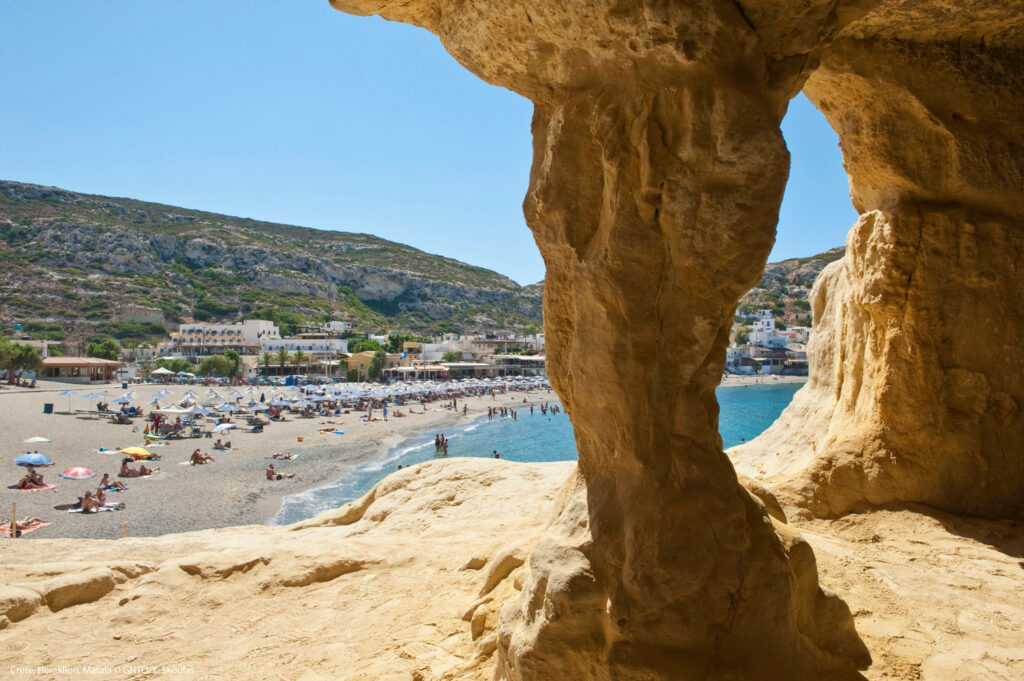 Matala beach with caves on the rocks that were used as an early Christian cemetery and at the decade of 70's were living hippies from all over the world, Crete, Greece, photo Y Skoulas