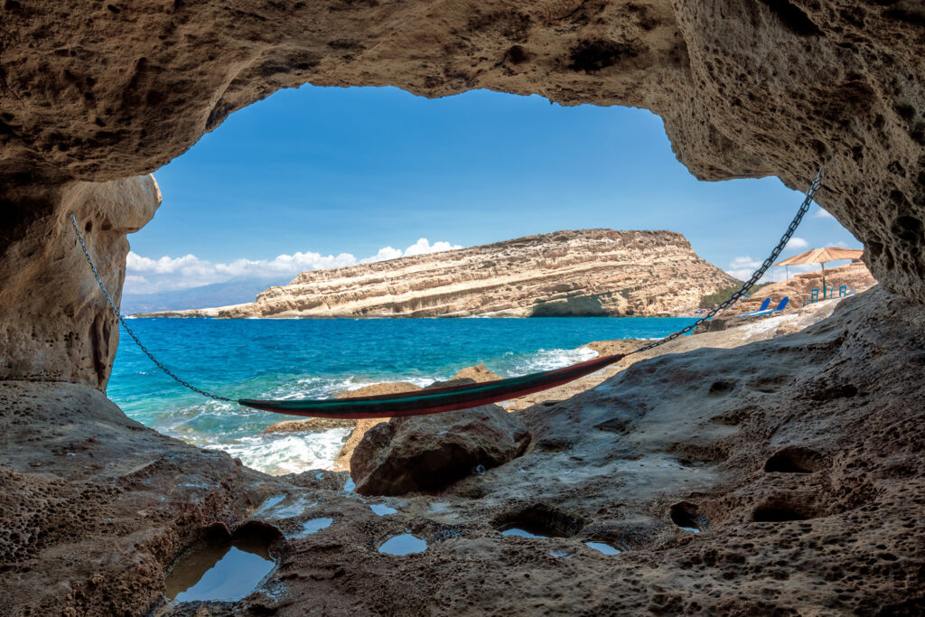 Matala beach with caves on the rocks that were used as an early Christian cemetery and at the decade of 70's were living hippies from all over the world, Crete, Greece